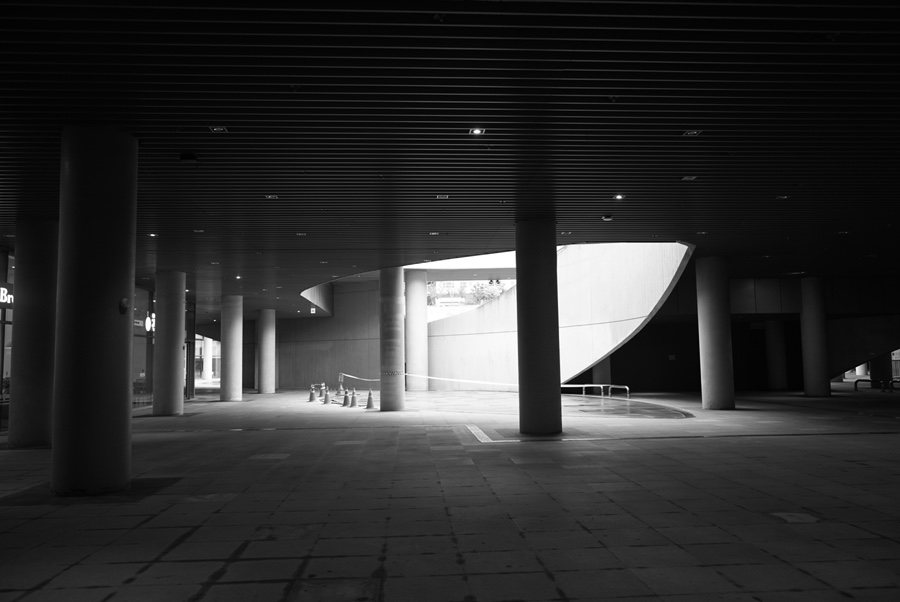 Dark passage opening into a bright plaza