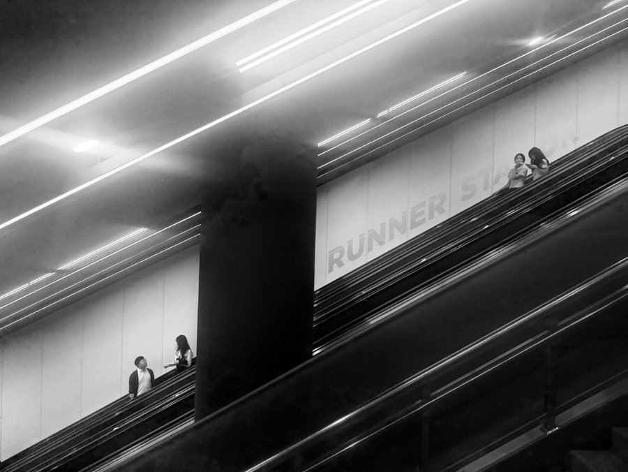 People riding an escalator