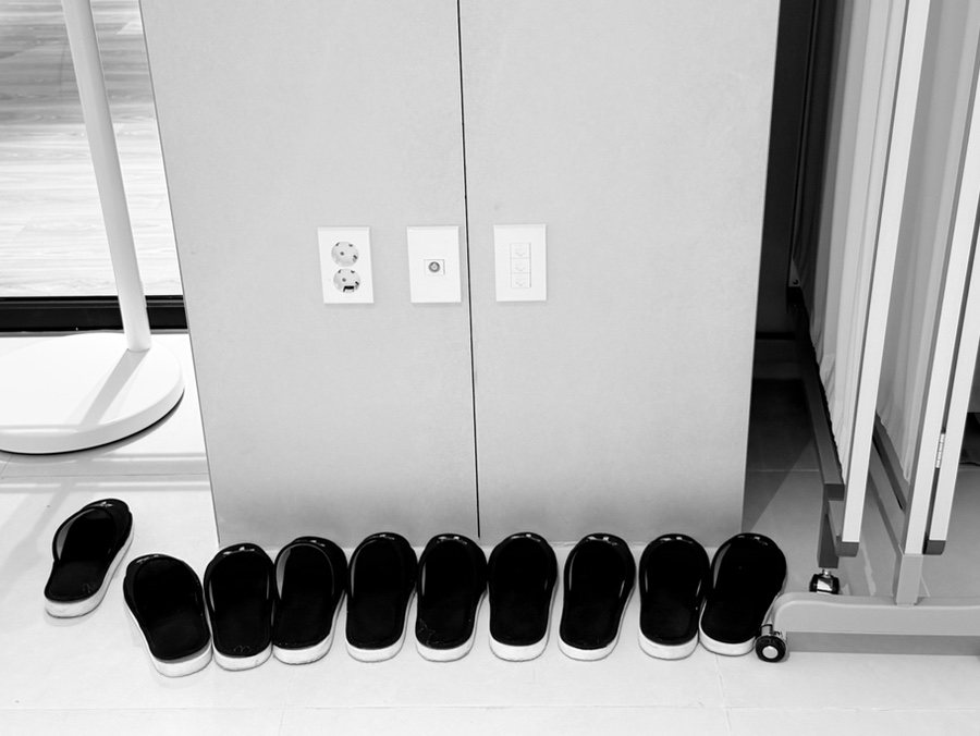 Slippers lined up against a wall